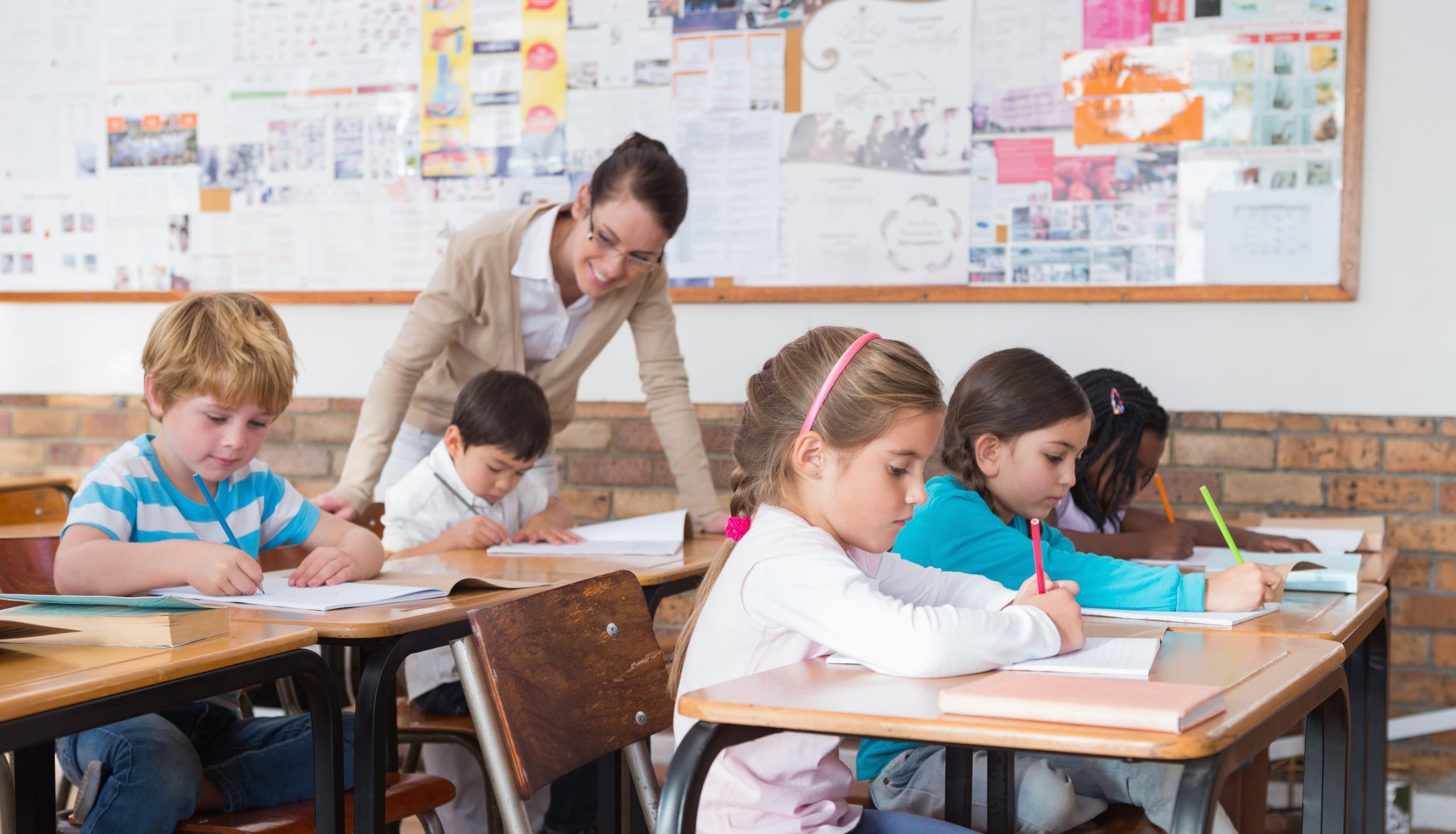 Teacher helping her pupils in their lesson